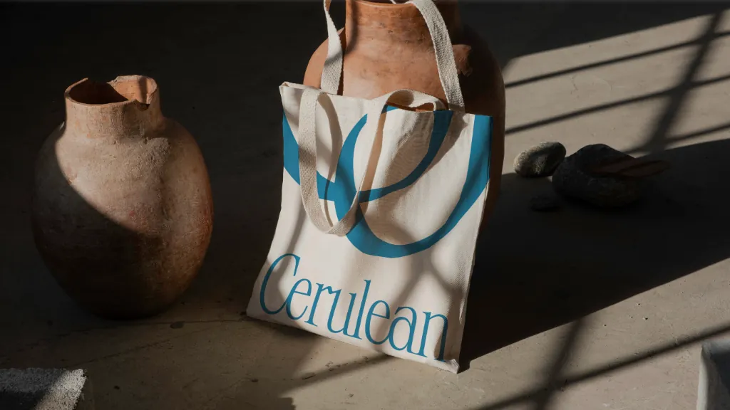 A canvas tote printed with the Cerulean wordmark and a large, cropped monogram in cerulean.