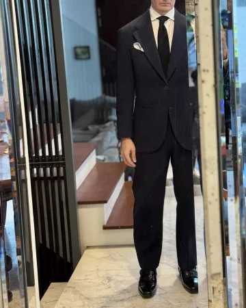 John Philip Green in a dark suit, white shirt and dark tie.