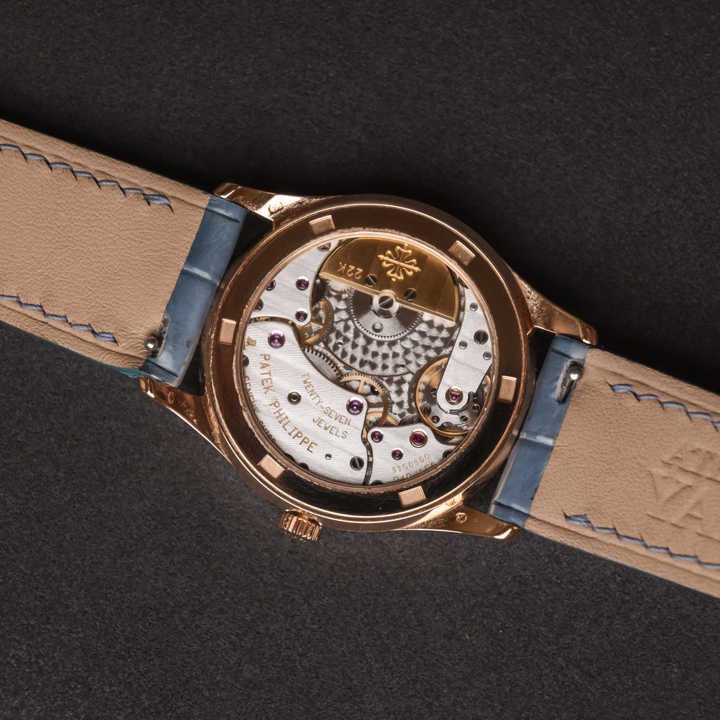 The Calatrava exhibition caseback showing the small gold rotor and decorated movement