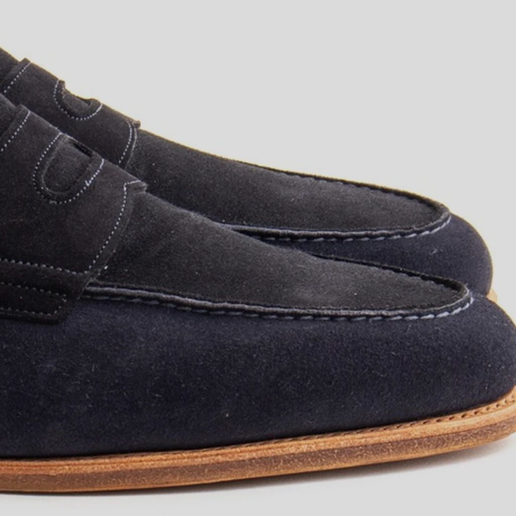 The navy suede upper and stitched apron of John Lobb Lopez loafers